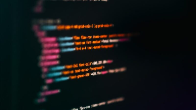 Close-up of colorful code on a screen representing an AI browser automation agent