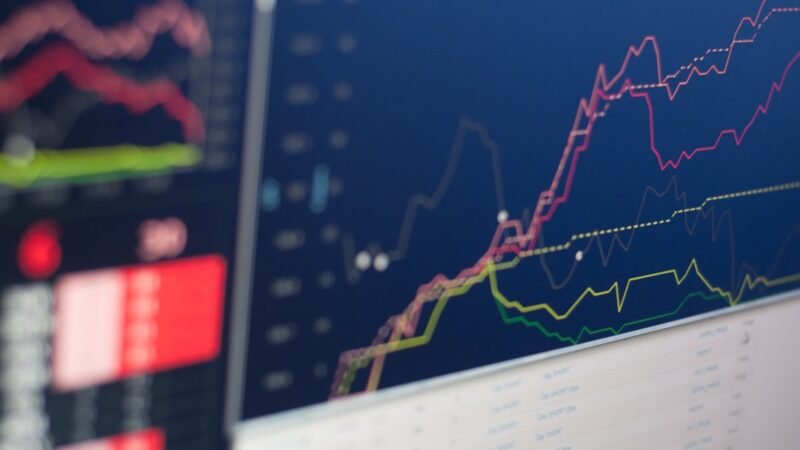 Stock trading charts on screen during a live trading session, representing AI trading-signal tools