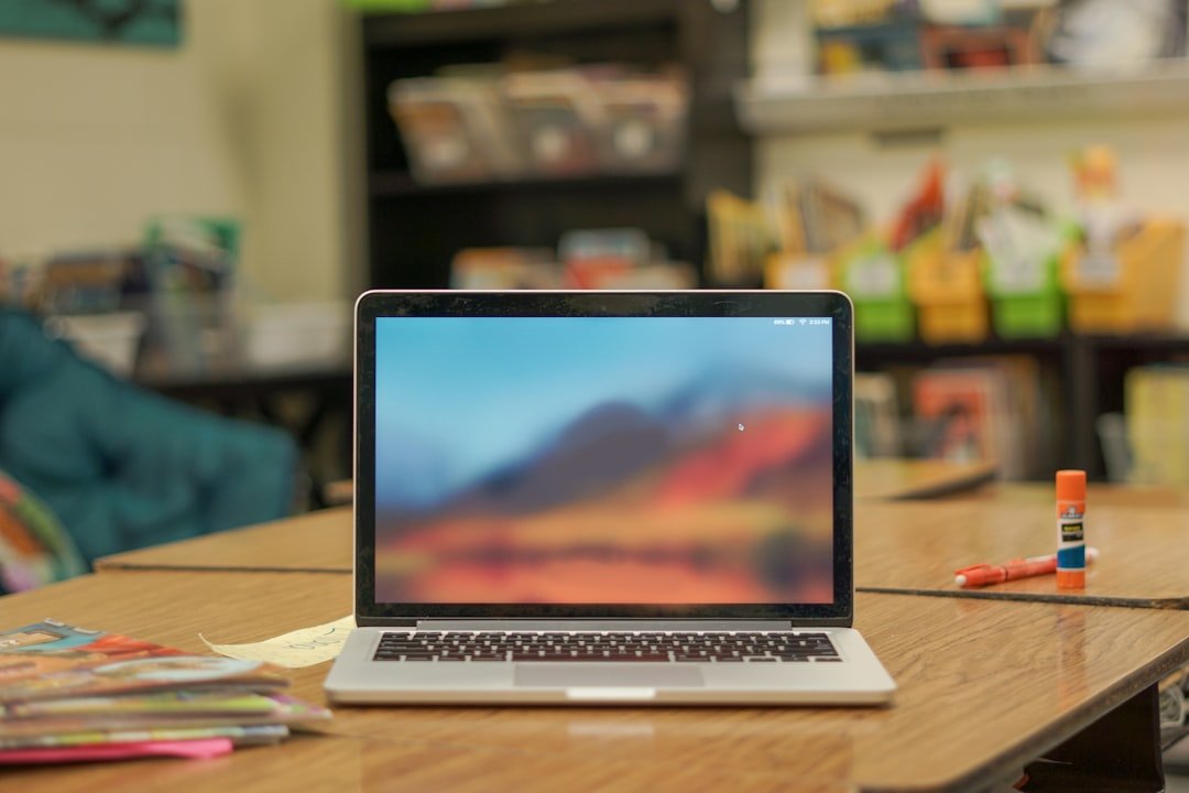 Laptop on a desk in a school classroom representing an AI teaching assistant tool