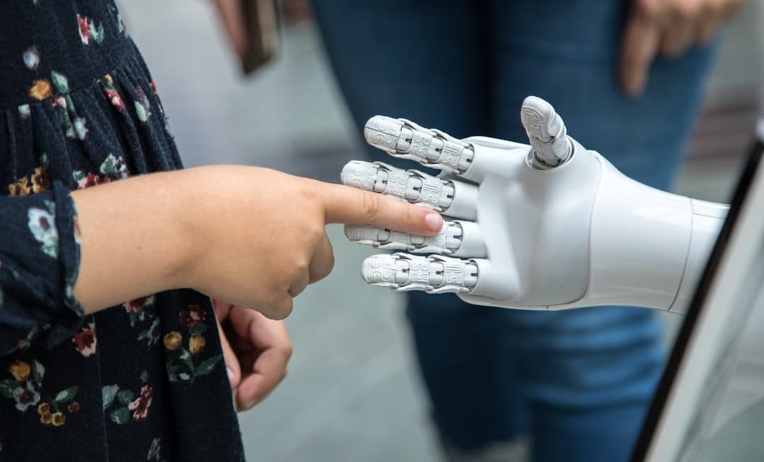 A child touching the finger of a white robotic hand, representing trust and boundaries in AI systems