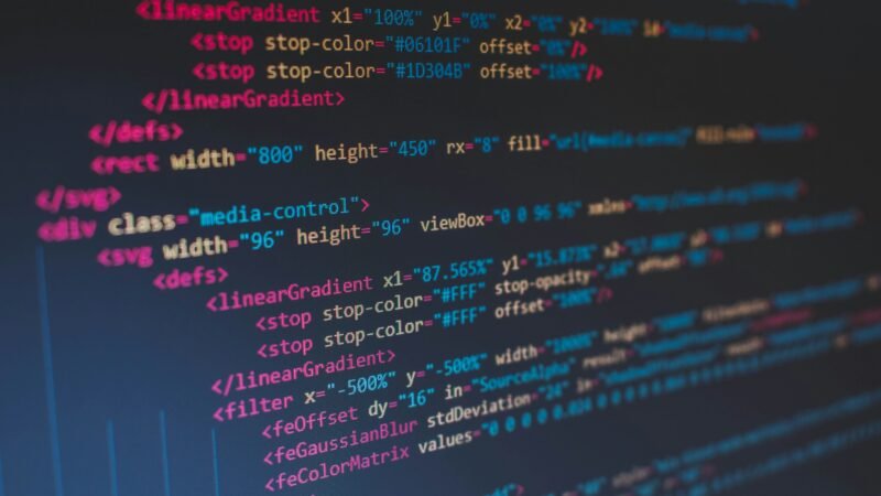 Developer working on a laptop with code on screen, representing AI powered app building