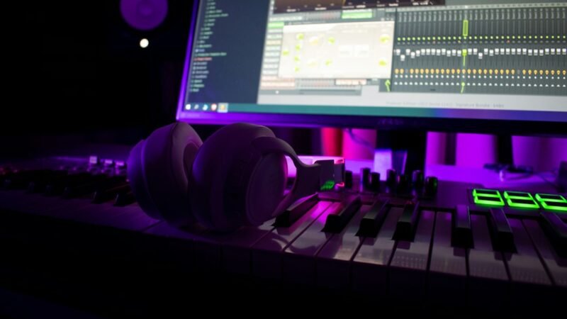 Music production studio with headphones on a MIDI keyboard, symbolizing AI music platform Suno