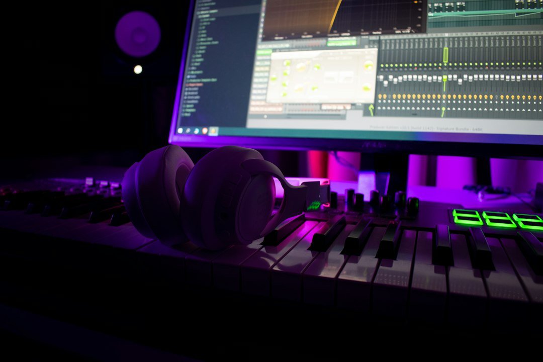 Music production studio with headphones on a MIDI keyboard, symbolizing AI music platform Suno