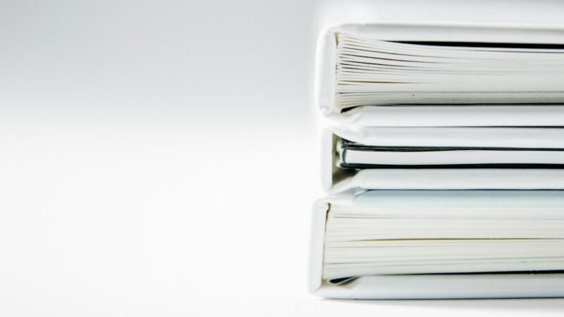 Stack of legal folders representing the years-long Apple patent lawsuit