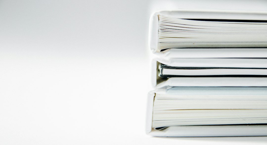 Stack of legal folders representing the years-long Apple patent lawsuit
