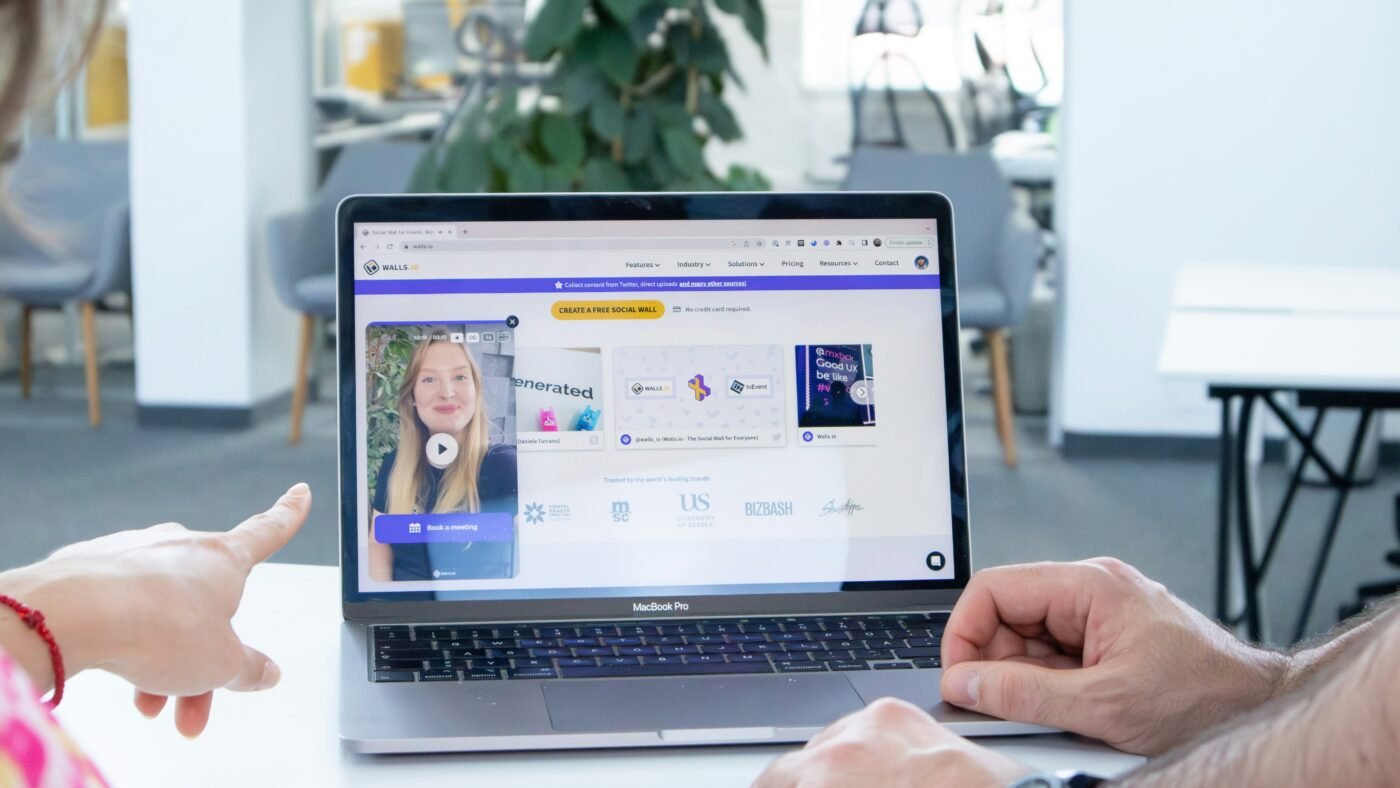 Two people looking at a laptop screen, illustrating a conversational AI ad experience
