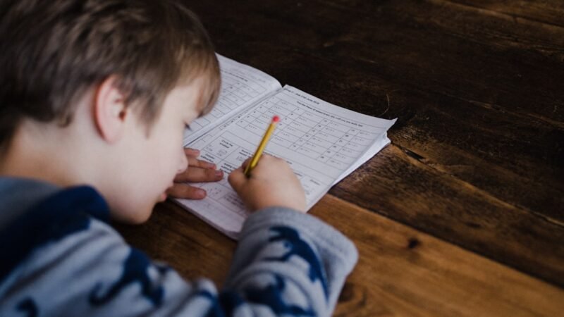 Child working through a math homework problem, representing an AI homework helper app