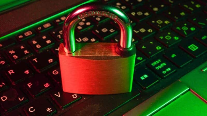 Digital padlock icon over a stream of binary code representing a cybersecurity data breach
