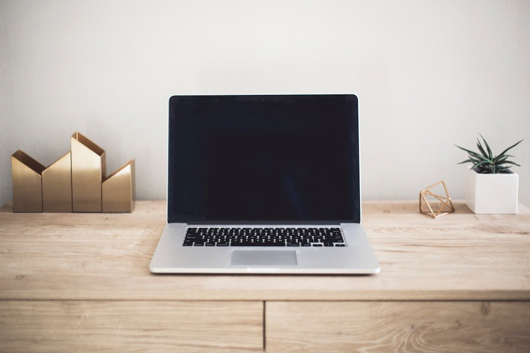 Laptop and notebook on a desk used for digital advertising campaign planning