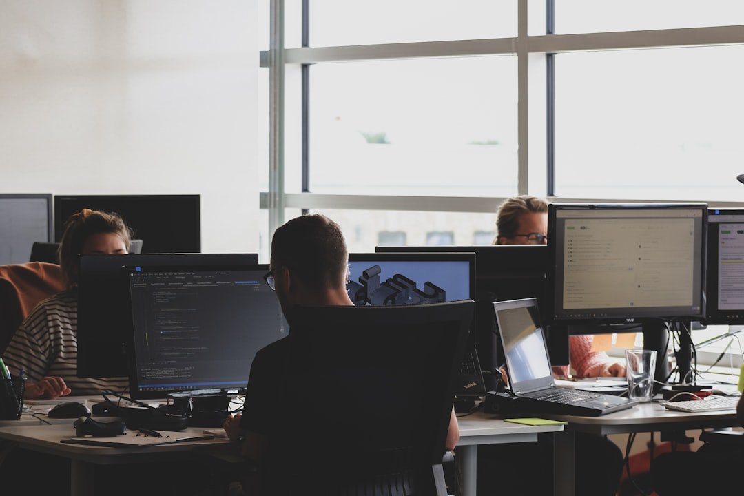 Team monitoring network security screens in an office