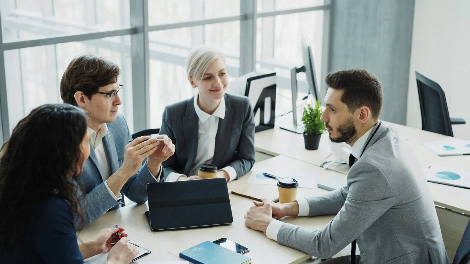 Business colleagues discussing a project at a table in a modern office