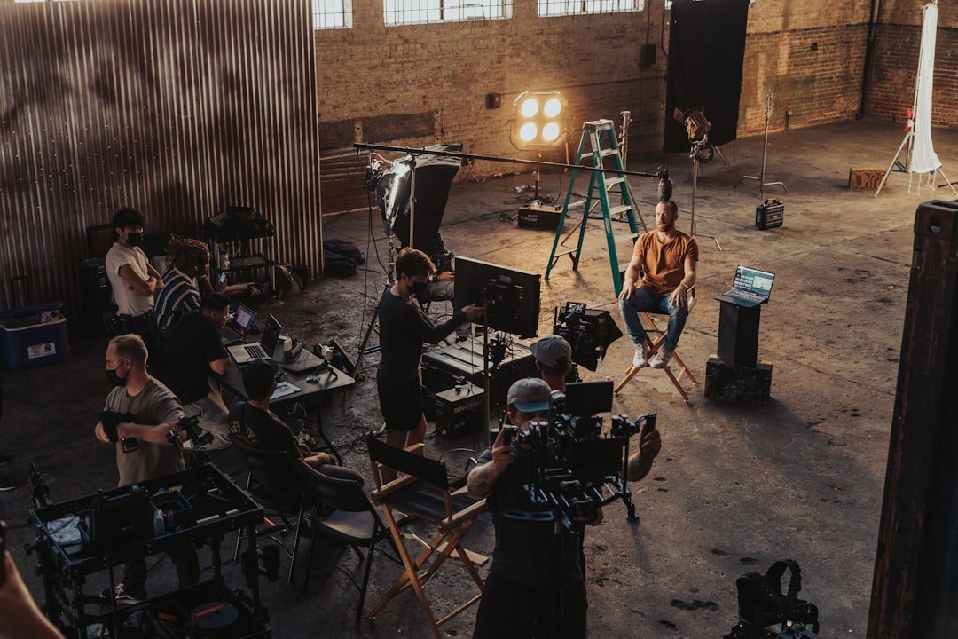 Film crew standing around a camera setup on a production set, representing the merged Paramount and Warner Bros. studios