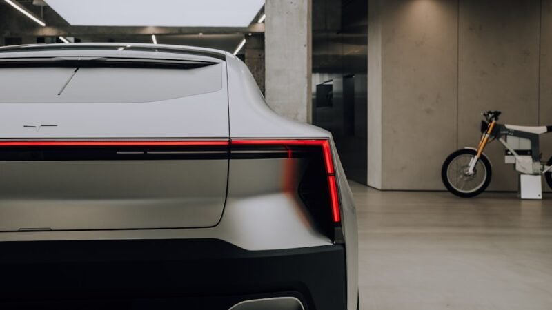 Sleek futuristic electric sports car with tight lines on display in a showroom