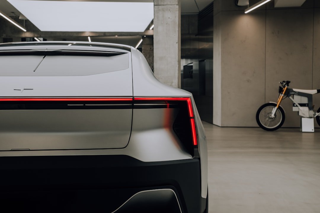 Sleek futuristic electric sports car with tight lines on display in a showroom