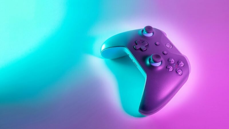 Video game controller lit by neon light, representing Minecraft's expansion across consoles