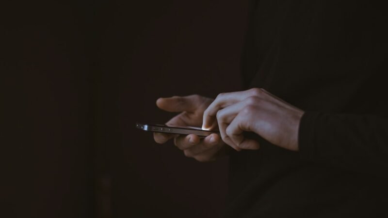 Person holding a smartphone up to make a call