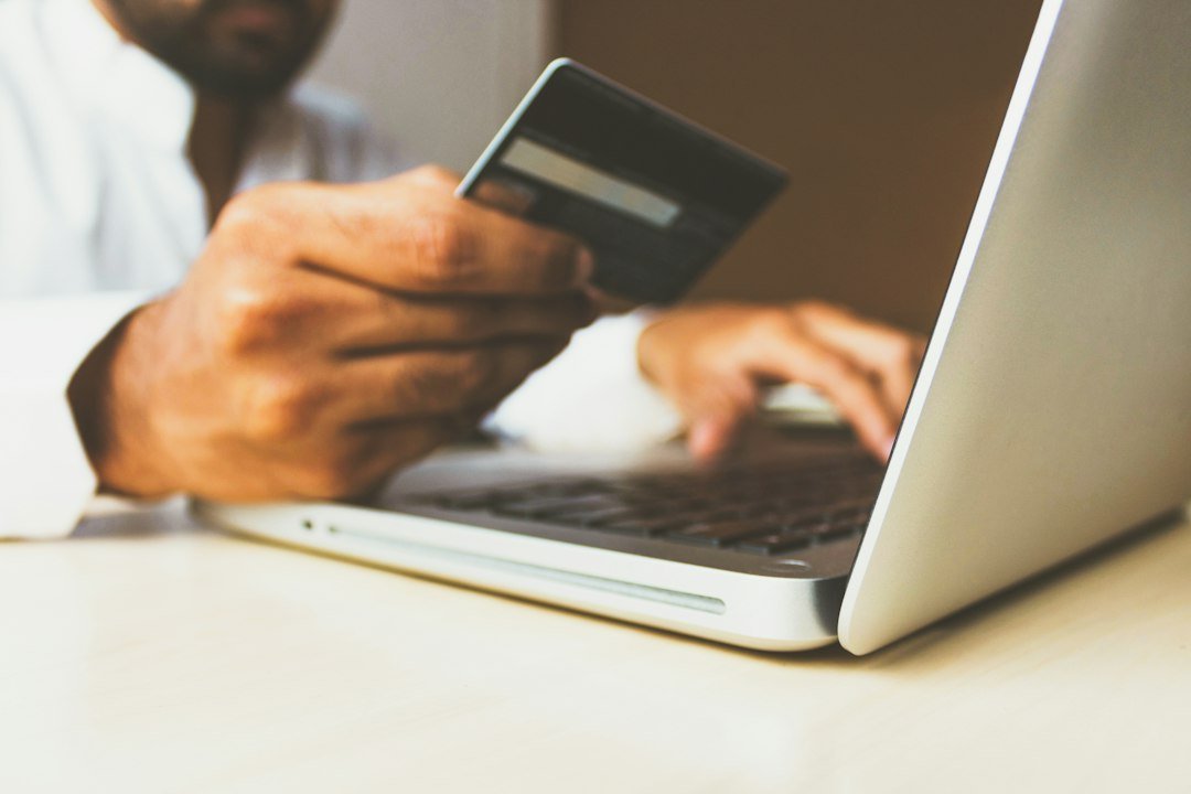 Person holding a credit card while completing an online checkout