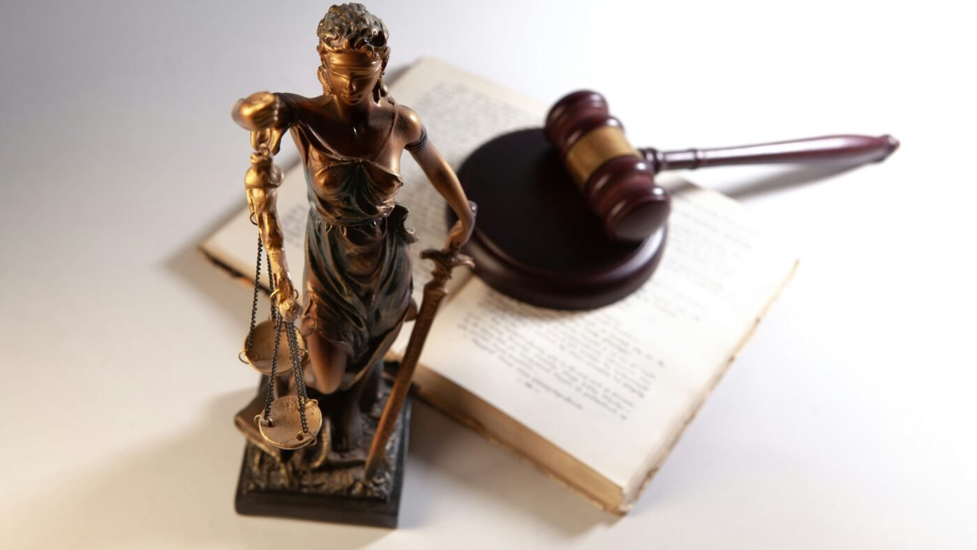 Statue of justice with gavel and law books, representing the Google ad tech antitrust ruling