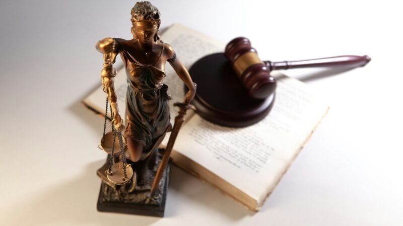 Statue of justice with gavel and law books, representing the Google ad tech antitrust ruling