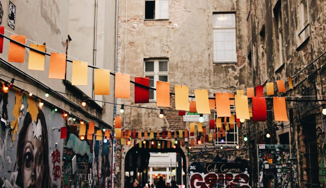 European city street lined with shops and flags