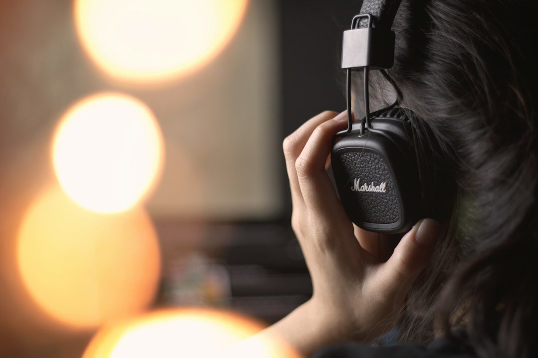 Person wearing headphones listening to music, illustrating AI-generated music platforms
