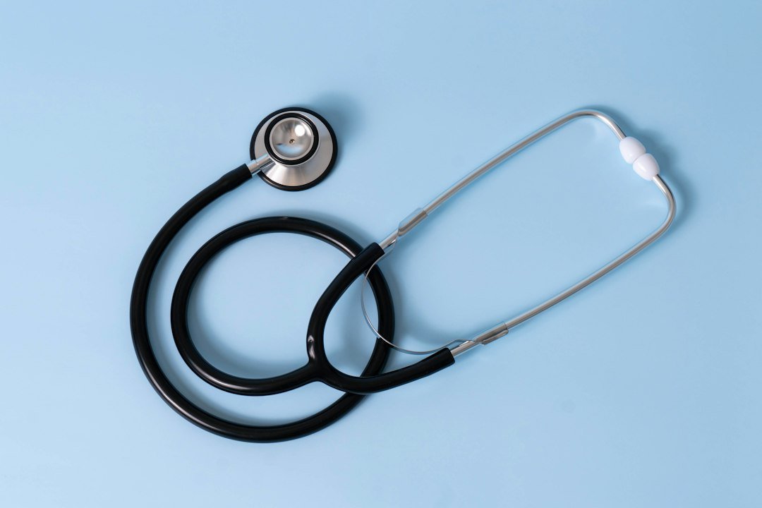 Medical billing paperwork and a stethoscope on a desk, representing AI-driven healthcare coding costs