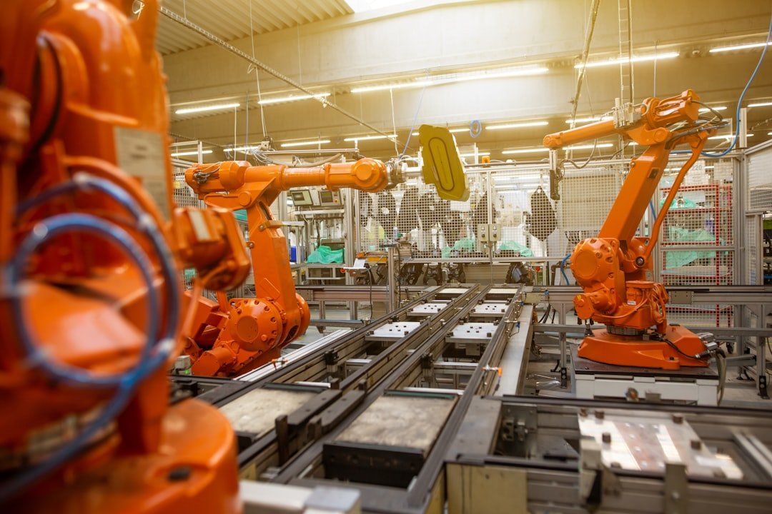 Industrial robotic arms assembling products on a factory line