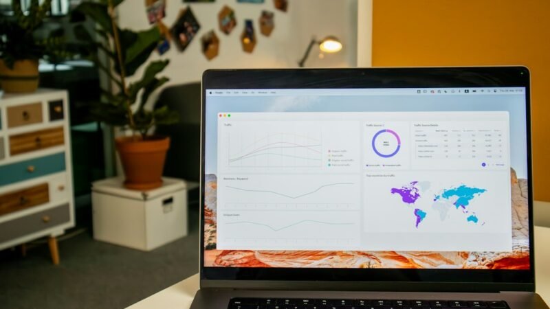 Laptop on desk displaying search analytics statistics on screen