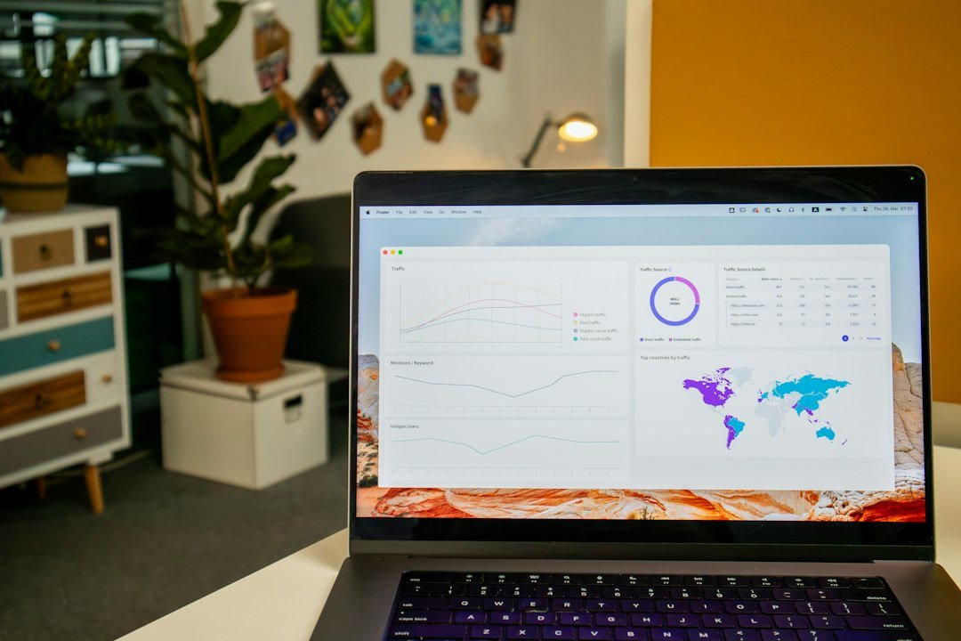 Laptop on desk displaying search analytics statistics on screen