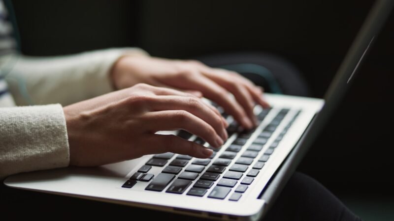 Person using a laptop at night, representing AI chatbot demand
