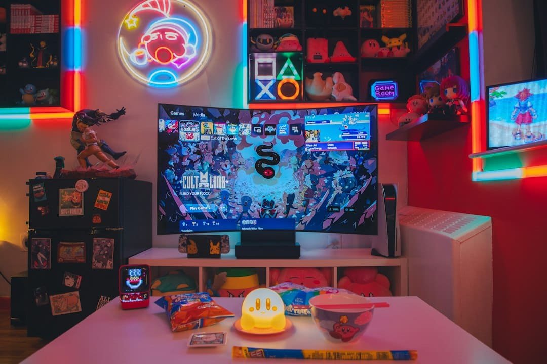 A living room gaming setup with a large television and colorful neon accent lighting