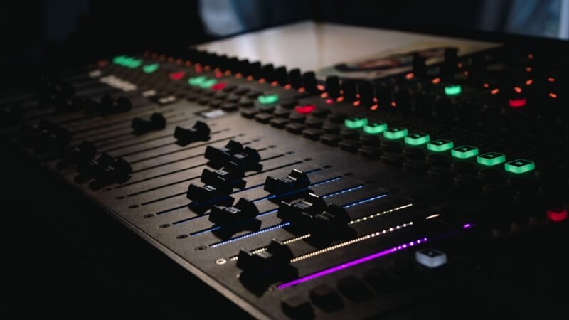 DJ mixing console with illuminated buttons in a music studio