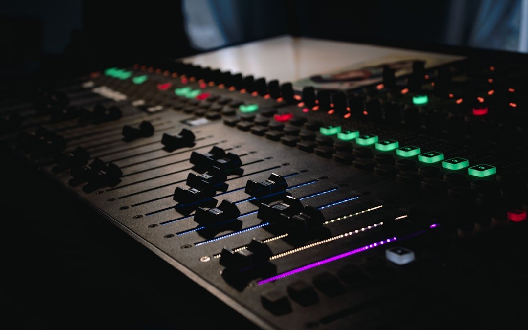 DJ mixing console with illuminated buttons in a music studio