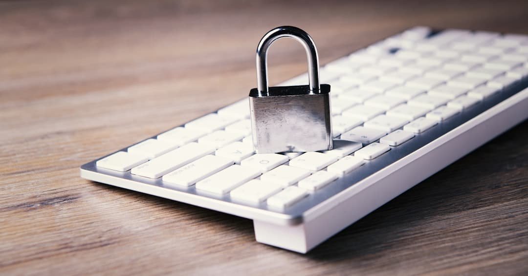 A padlock resting on a computer keyboard symbolizing stolen personal identification data