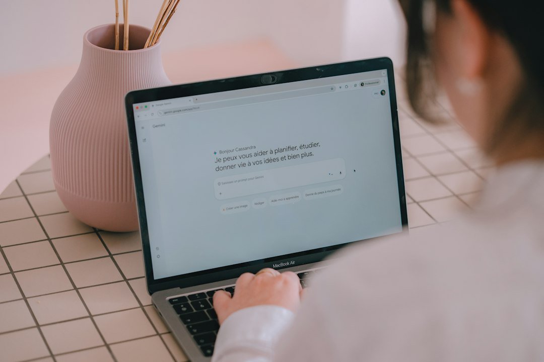 Person typing a prompt into an AI chatbot on a laptop