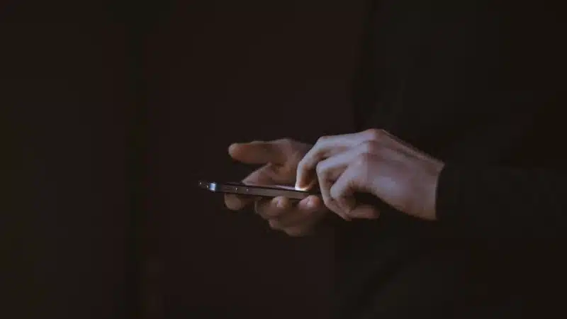 A person looking at a smartphone screen, representing social media platform advertising