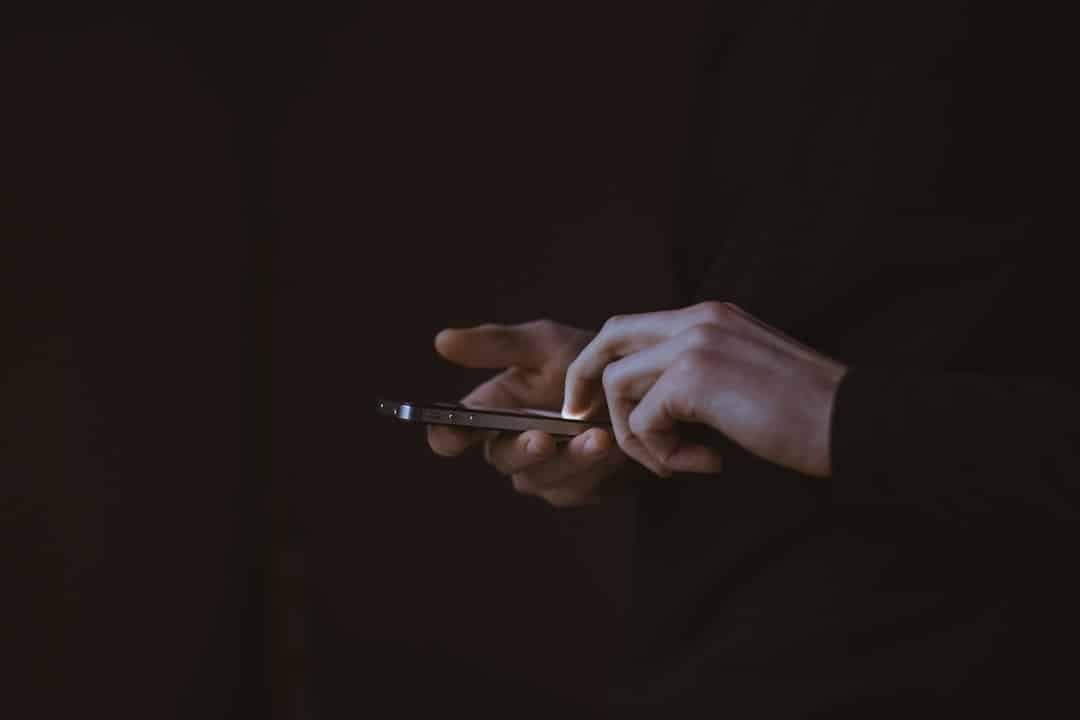 A person looking at a smartphone screen, representing social media platform advertising