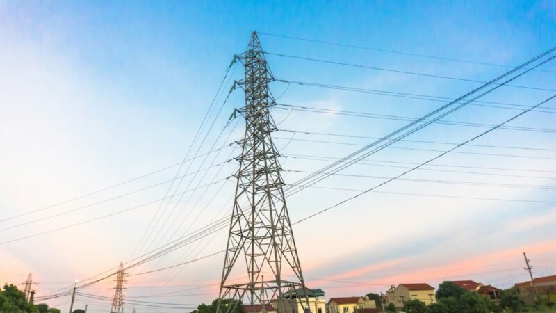 High-voltage power transmission lines at sunset