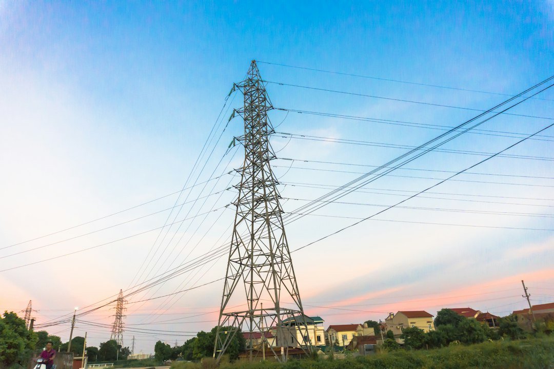 High-voltage power transmission lines at sunset