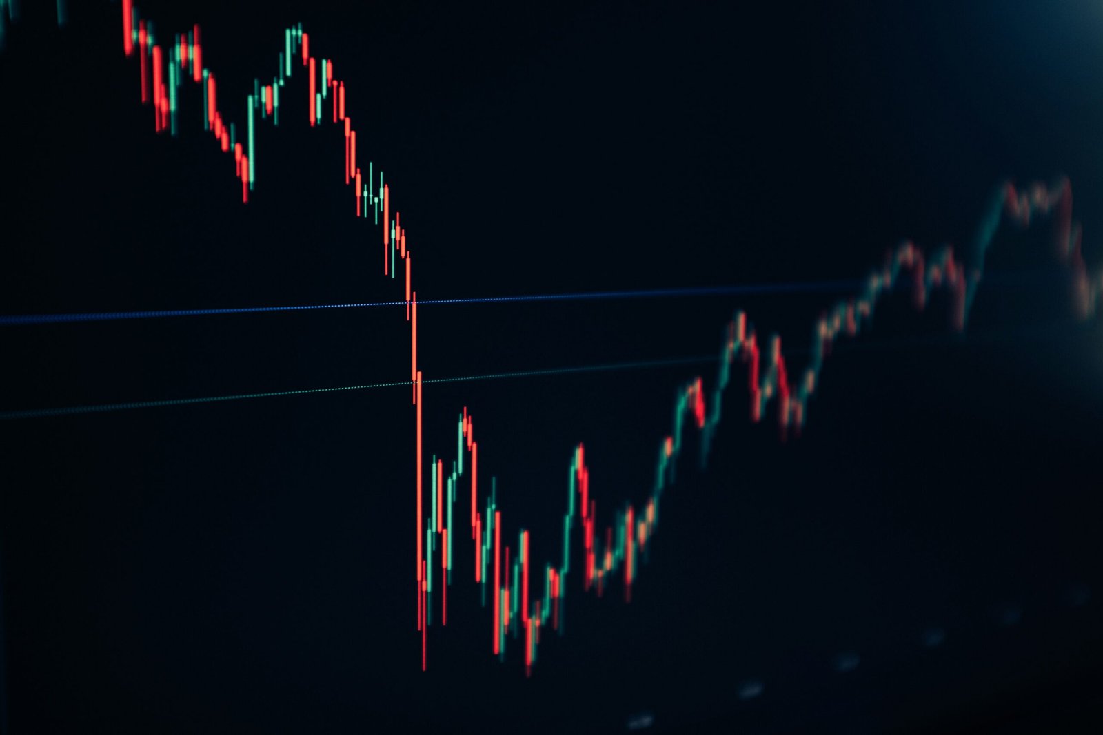 Candlestick stock chart on a dark screen showing a sharp upward trend, representing revenue growth