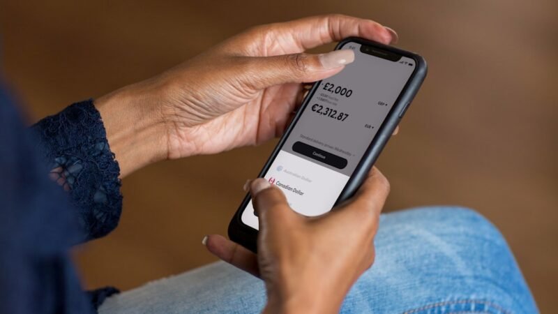 Hands holding a smartphone open to a mobile banking app