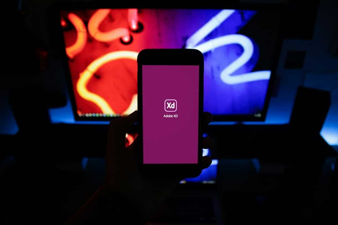 Person holding a smartphone scrolling a vertical video feed, similar to Prime Video's new short-form news format