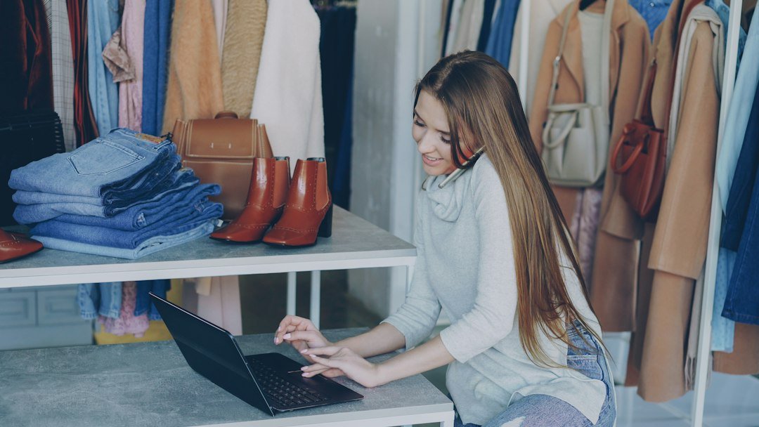 Small business owner using a laptop for free AI tools inside her shop
