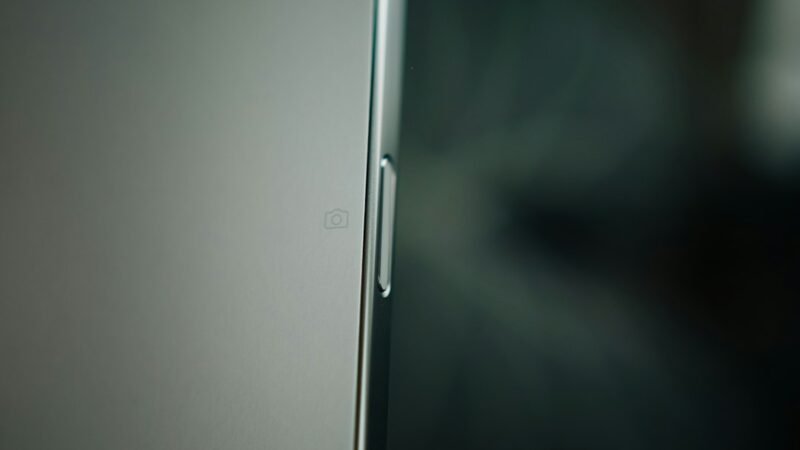Close-up macro shot of a smartphone's smooth side profile, representing precision hardware engineering