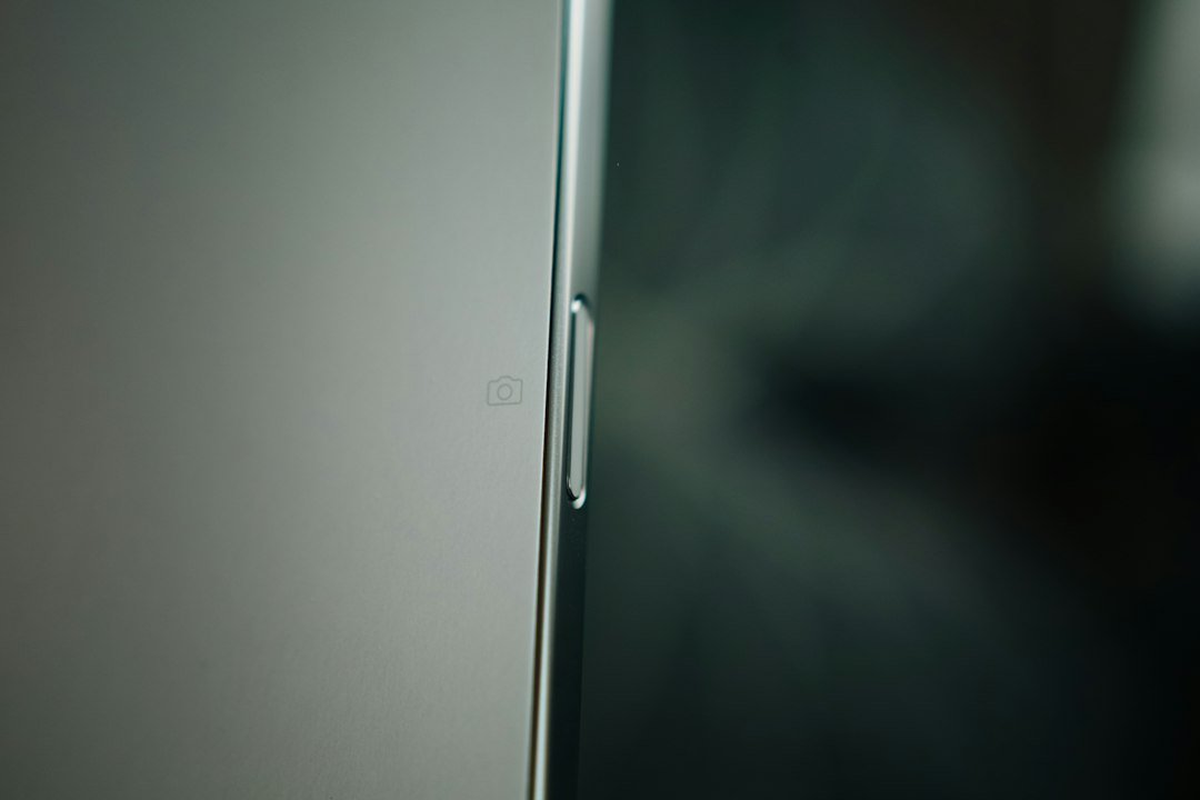 Close-up macro shot of a smartphone's smooth side profile, representing precision hardware engineering