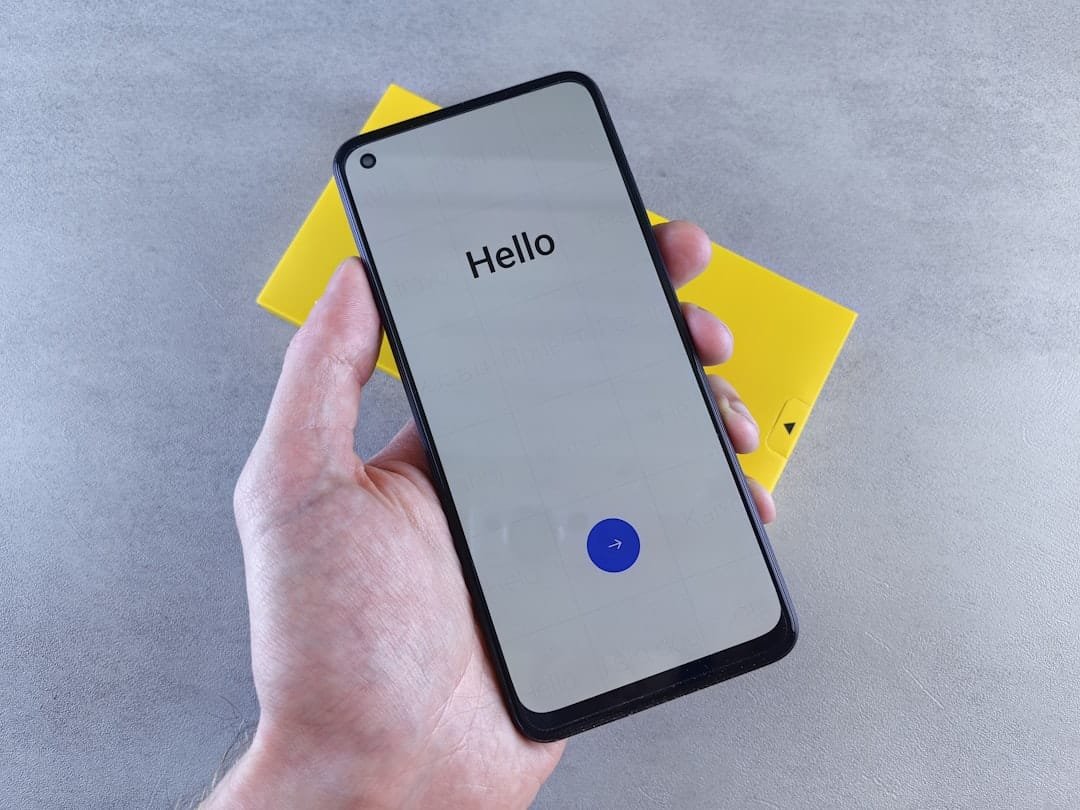 Person holding a smartphone in hand, representing Apple's updated Siri voice assistant in iOS 27