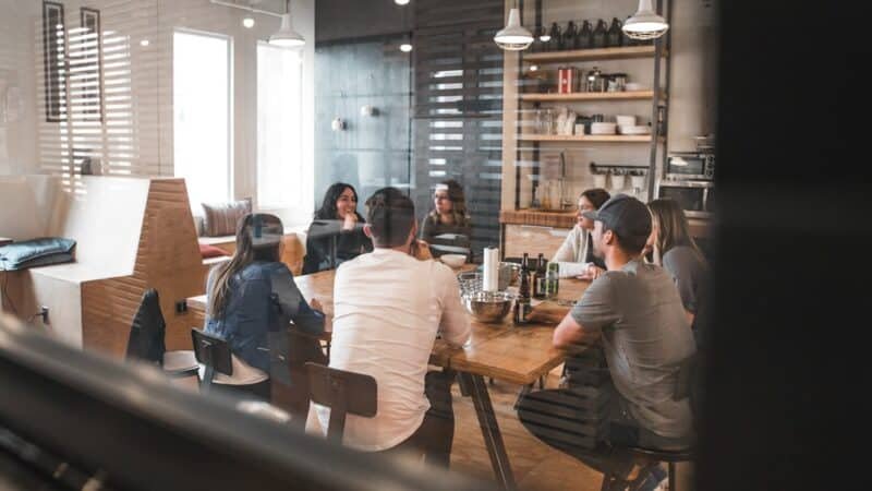 Startup founders collaborating around a table during a pitch meeting