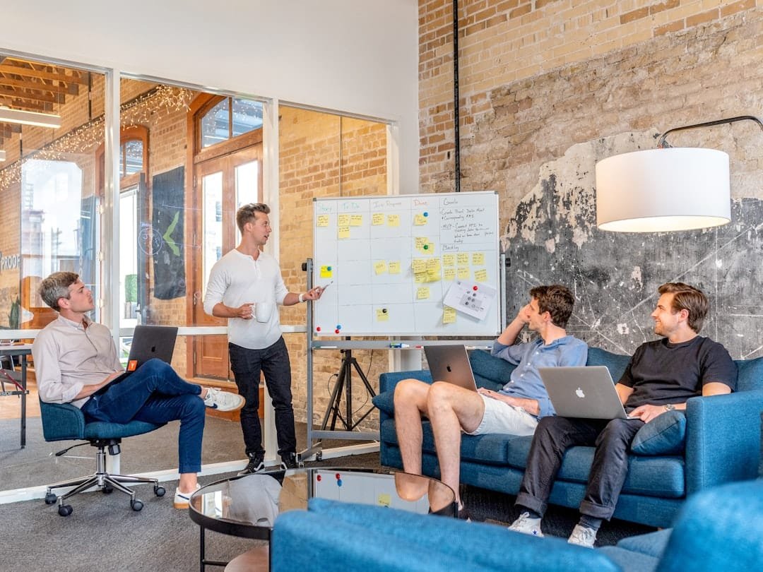 Team members reviewing a presentation on a whiteboard during a startup planning session