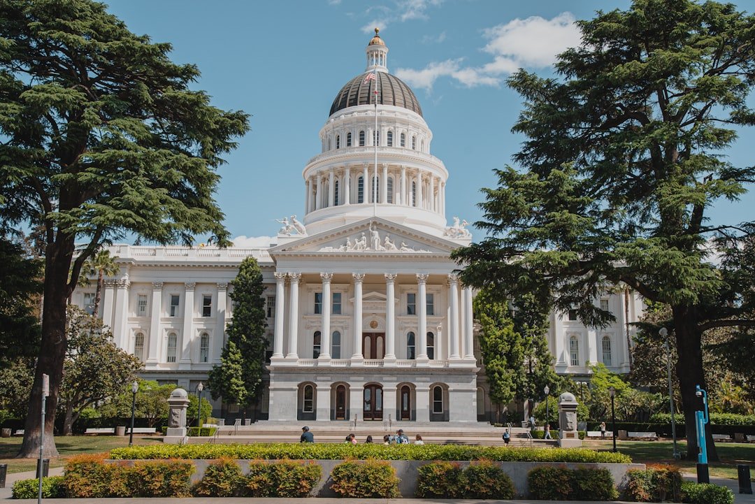 White government building with a dome, representing state capitol architecture
