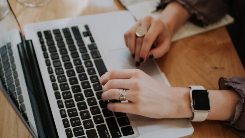 Student typing an essay on a laptop, representing an AI essay-writing tool